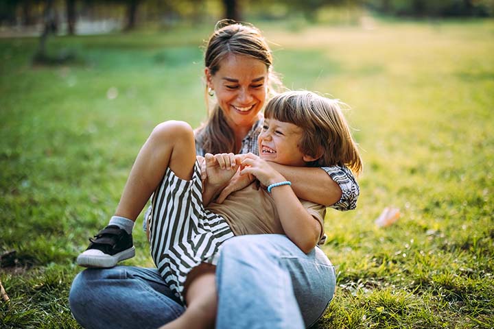 Mom and son play in the grass