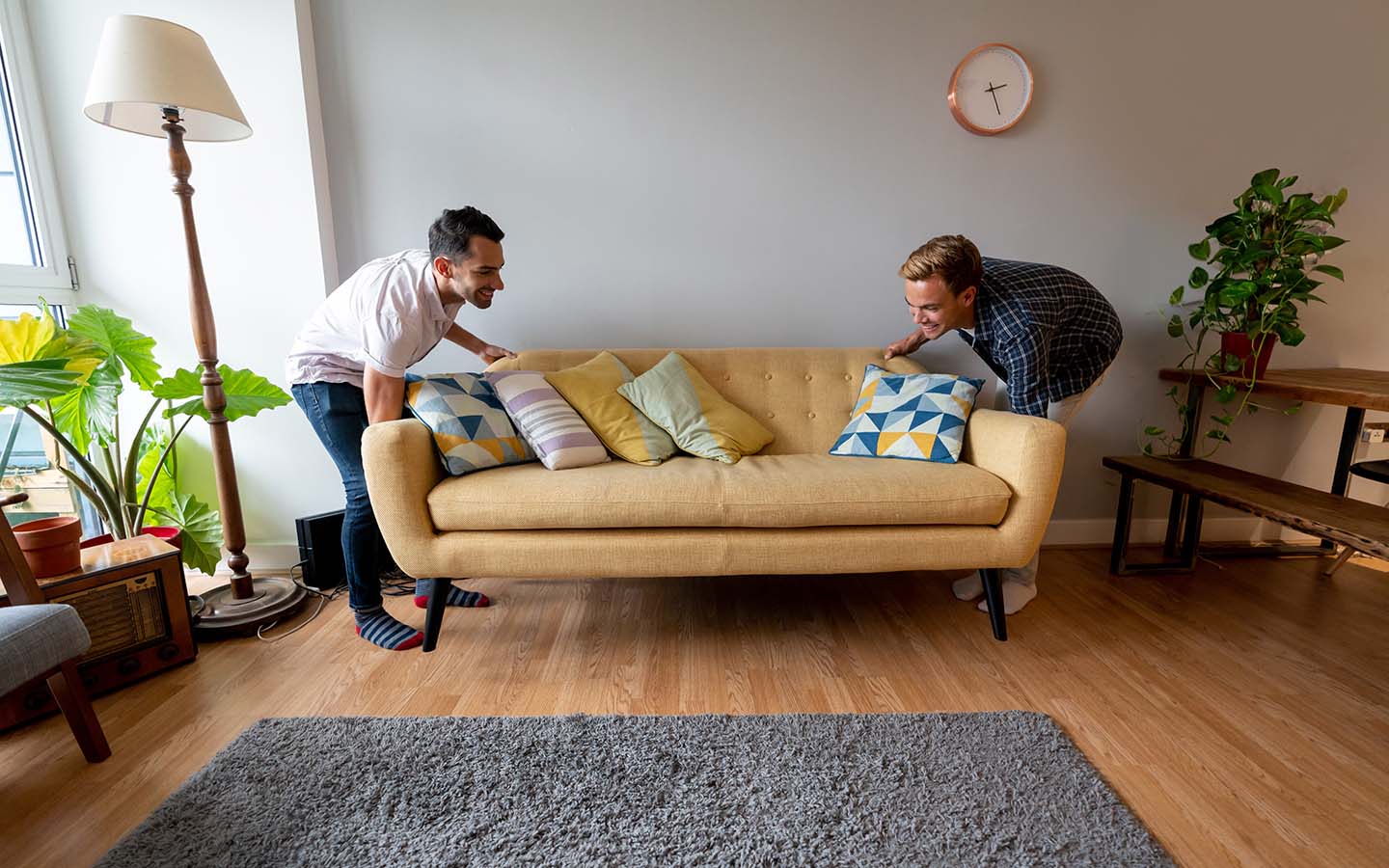 PersonalLoans_1440x900 Young male couple move living room sofa